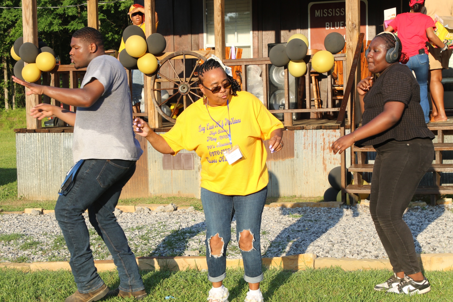 Three generations dancing in front of the barn stage