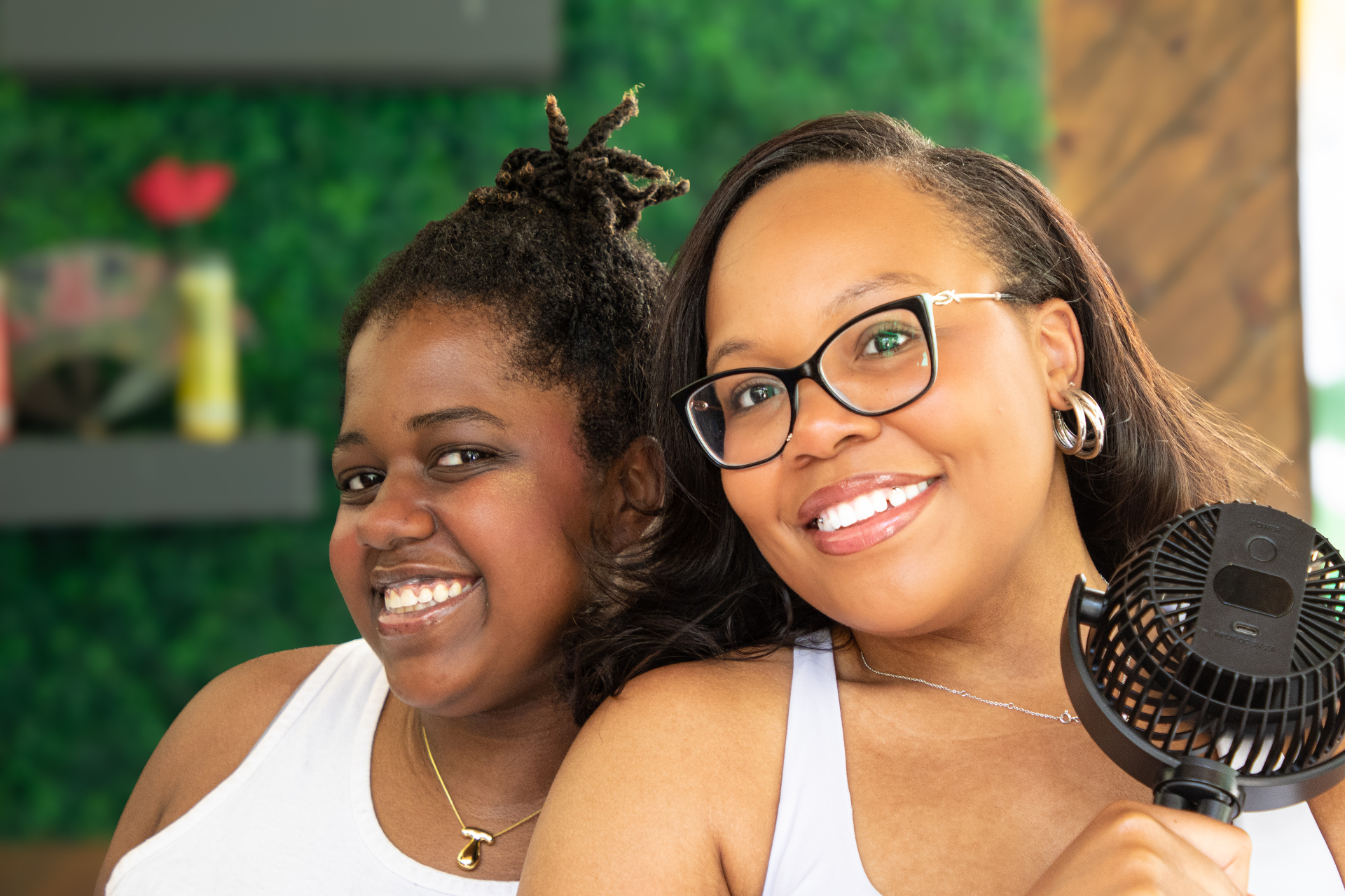 Two friends laughing indoors