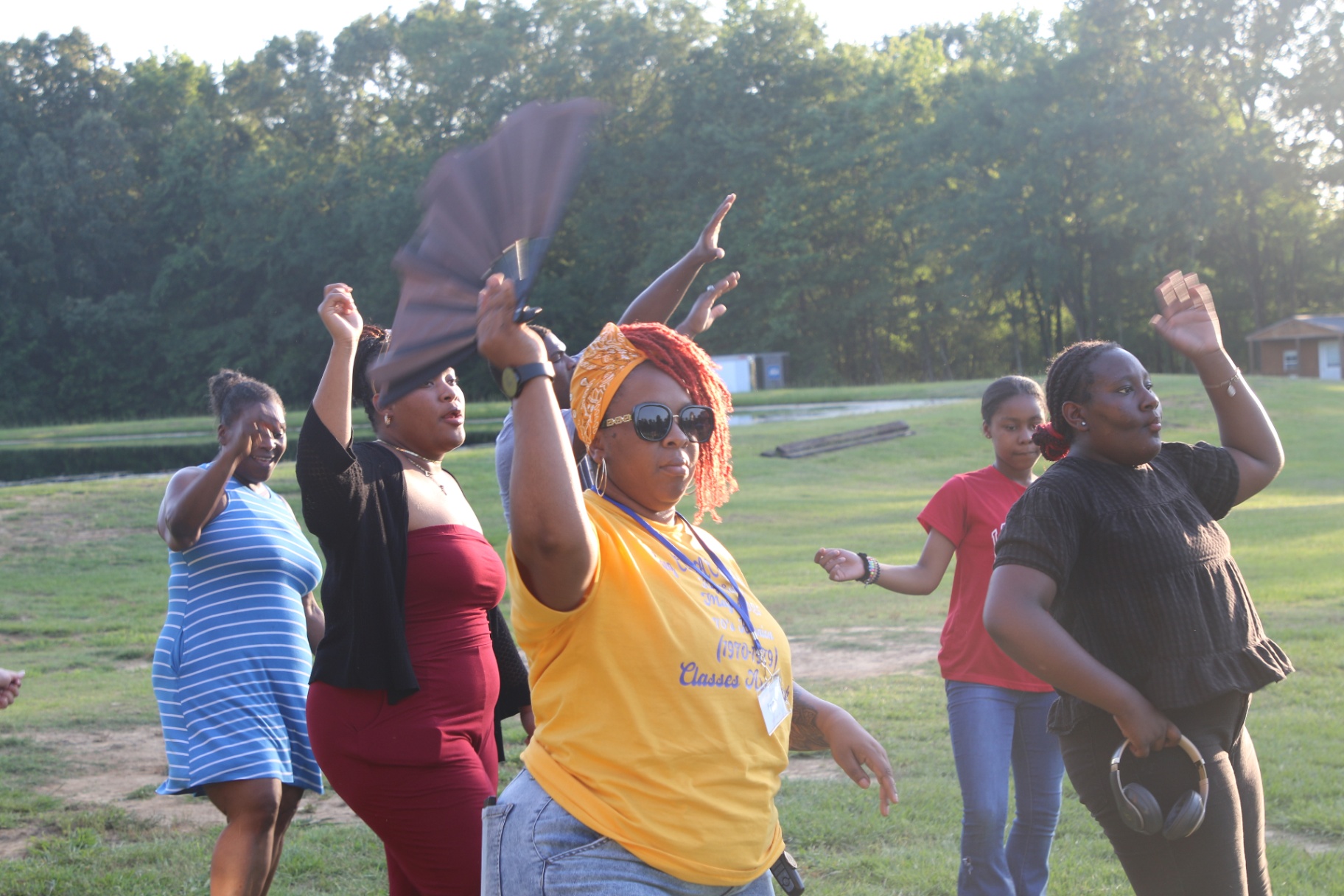 Line dancers on the grass at golden hour