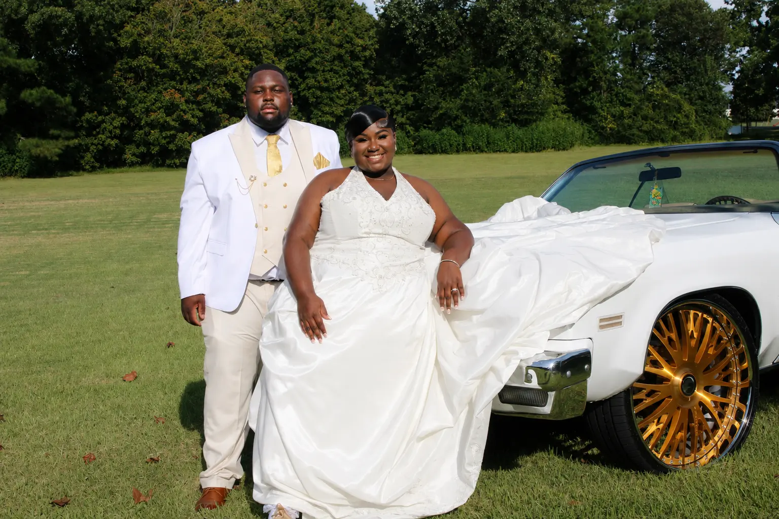 Couple leaning on white classic car
