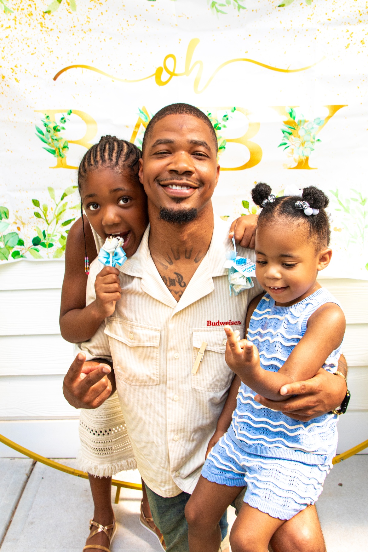 Dad with two young daughters at baby shower