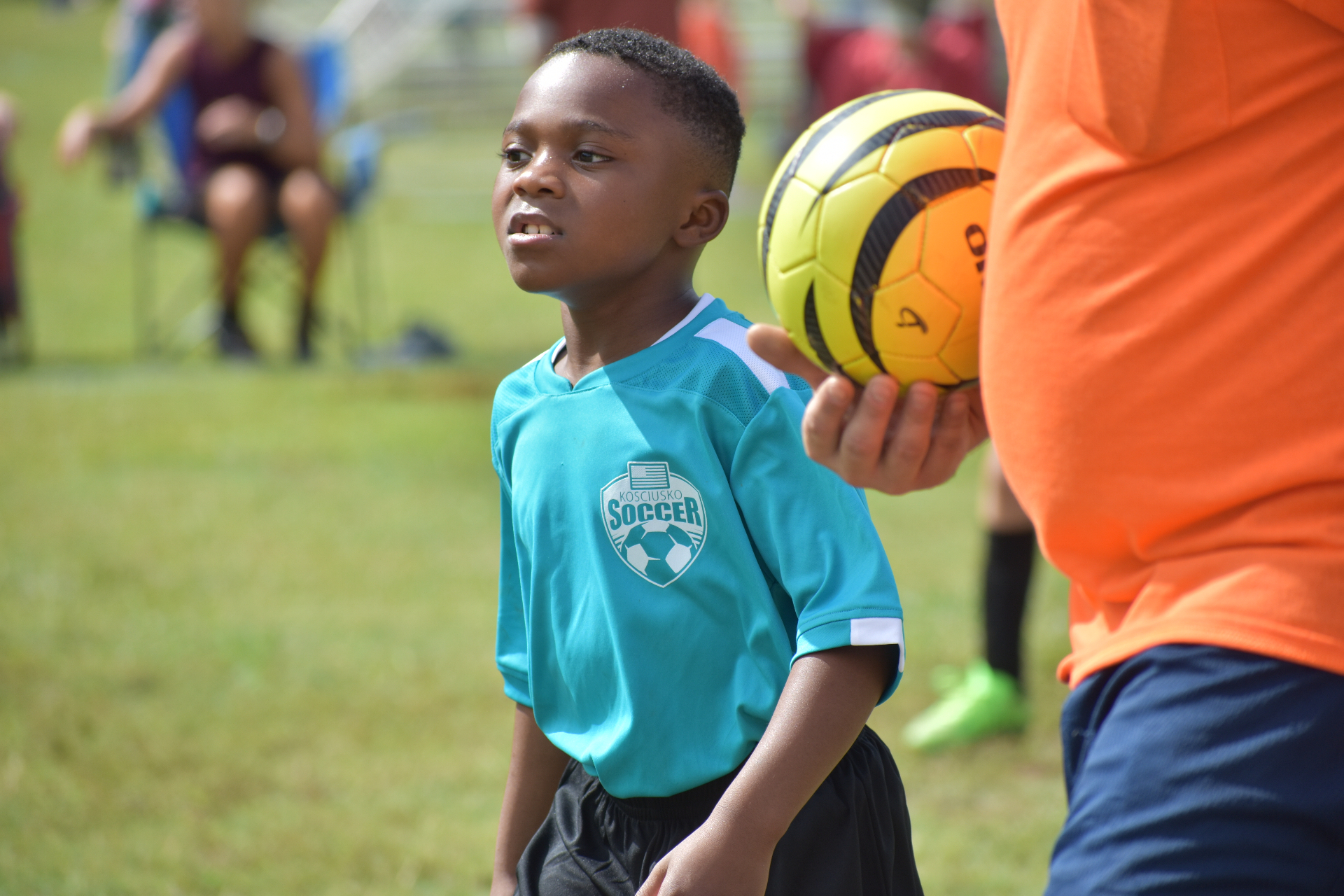 Young soccer player receiving ball