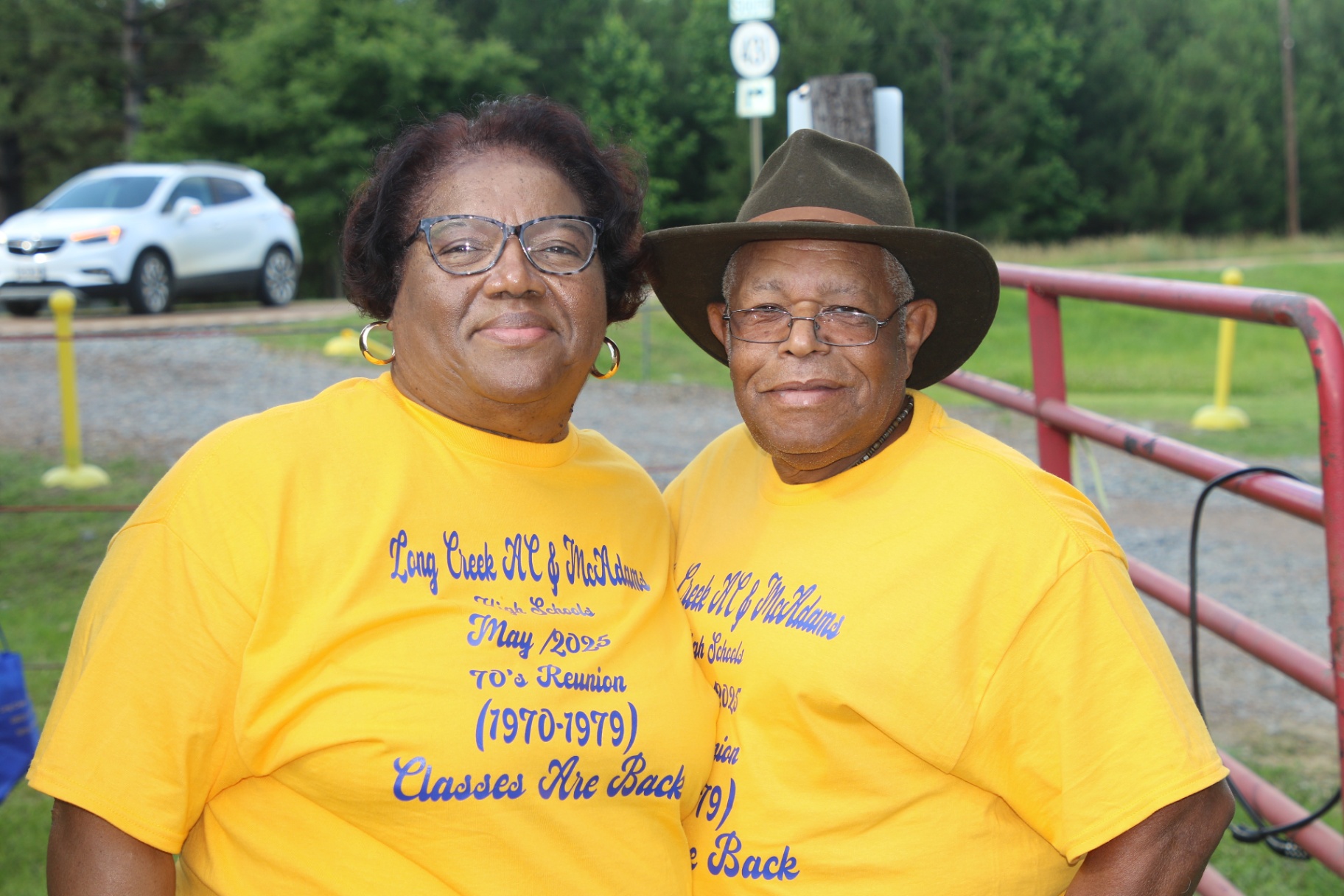 Couple in reunion tees by the red gate