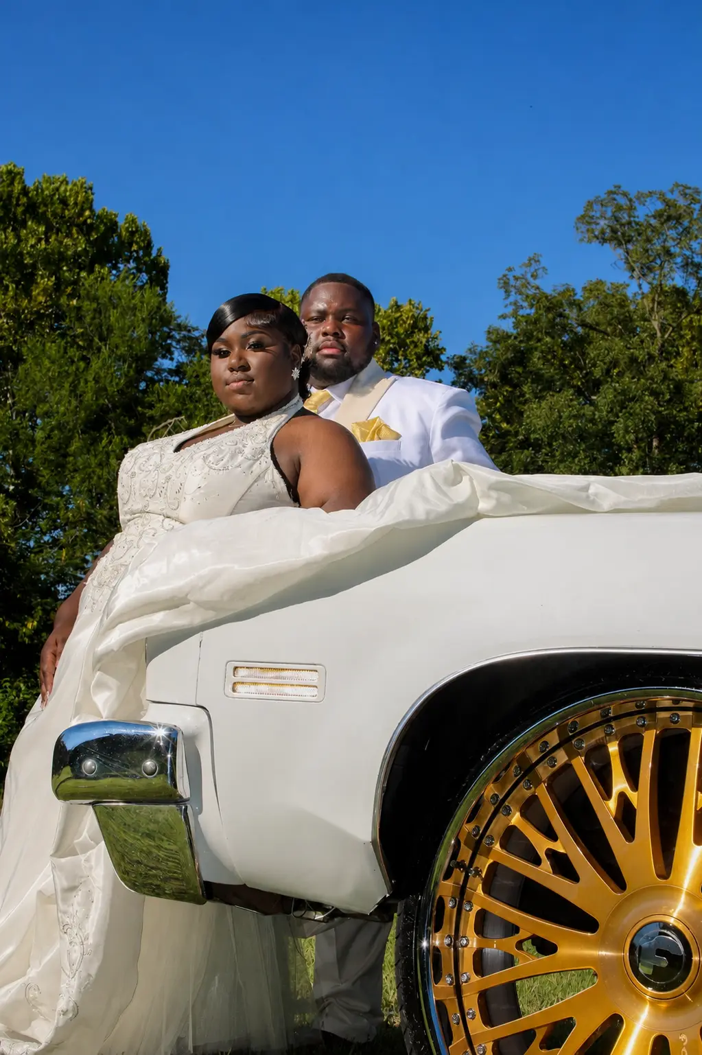 Bride and groom with white classic car